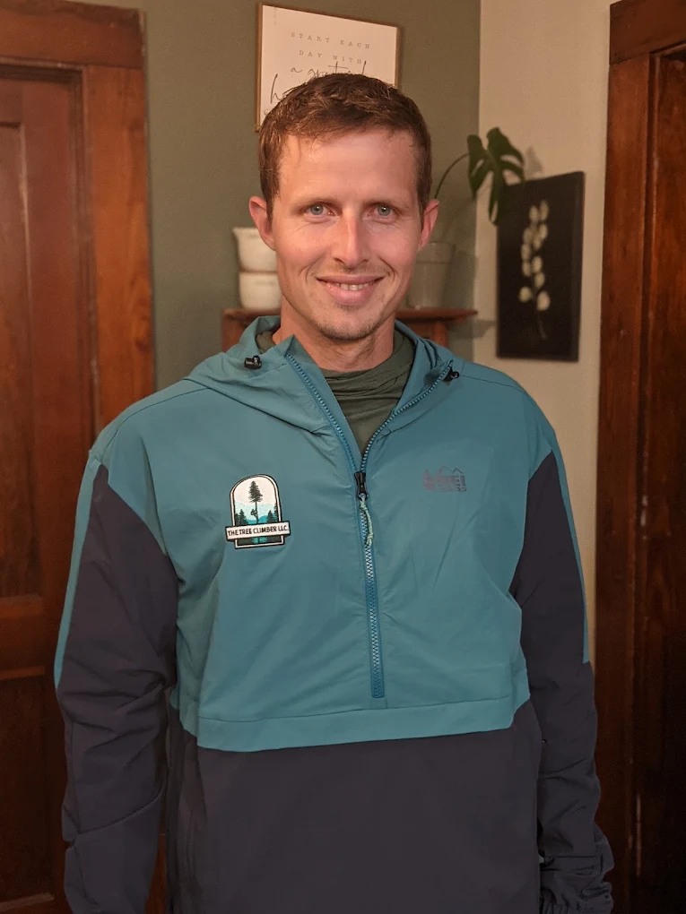 Kerry Meehan, owner of The Tree Climber LLC, wearing a branded Tree Climber jacket
